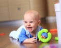 Angry baby boy learning to crawl annoyed Royalty Free Stock Photo