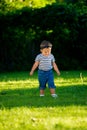 Angry baby girl walking on the lawn in the park Royalty Free Stock Photo