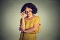 Angry bitchy serious woman with glasses in yellow dress skeptically looking at you