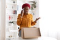 Angry black lady buyer looking inside delivery box and calling