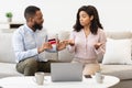 Angry black man blaming woman for wasting money Royalty Free Stock Photo