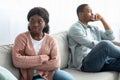 Angry black woman sitting apart from her frustrated boyfriend Royalty Free Stock Photo