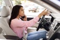 Angry black woman talking on cell phone while driving car Royalty Free Stock Photo