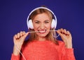 Angry blond in headphones biting cord