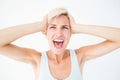 Angry blonde screaming and holding her head Royalty Free Stock Photo