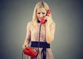 Angry blonde woman receiving bad news on the telephone