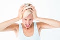 Angry blonde woman screaming and holding her head Royalty Free Stock Photo