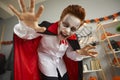 Portrait of a boy in a spooky vampire costume and scary makeup on Halloween night Royalty Free Stock Photo