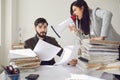 Angry boss businesswoman shouting at her office worker in a megaphone in the office