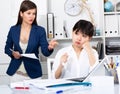 Upset asian woman with angry boss