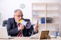 Angry boss holding megaphone at workplace Royalty Free Stock Photo