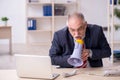 Angry boss holding megaphone at workplace Royalty Free Stock Photo