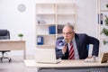 Angry boss holding megaphone at workplace Royalty Free Stock Photo