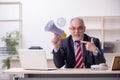 Angry boss holding megaphone at workplace Royalty Free Stock Photo