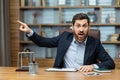 Angry boss shouts at the camera to the employee points his finger to the side dismisses the subordinate, a businessman Royalty Free Stock Photo