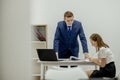 Angry boss yelling at his young employee, she is stressed and feeling frustrated: hostile boss and mobbing concept Royalty Free Stock Photo