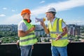 Angry boss yelling in megaphone at his builder on construction site Royalty Free Stock Photo