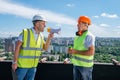 Angry boss yelling in megaphone at his builder on construction site Royalty Free Stock Photo