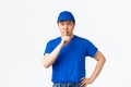 Angry and bossy serious-looking asian courier telling keep quiet, scolding employees misbehaviour at work. Delivery guy