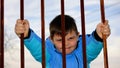 The angry boy demolishes the iron fence Royalty Free Stock Photo