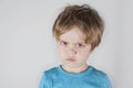 Angry boy frowning, looking forward. Light background. Closeup Royalty Free Stock Photo