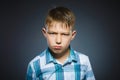 Angry boy isolated on gray background. Closeup Royalty Free Stock Photo