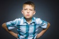 Angry boy isolated on gray background. Closeup Royalty Free Stock Photo