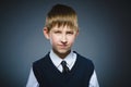Angry boy isolated on gray background. Closeup Royalty Free Stock Photo
