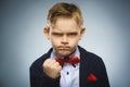 Angry boy isolated on gray background. He raised his fist to strike. Closeup Royalty Free Stock Photo