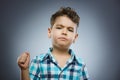 Angry boy isolated on gray background. He raised his fist to strike. Closeup Royalty Free Stock Photo