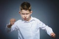 Angry boy isolated on gray background. He raised his fists to strike. Closeup Royalty Free Stock Photo
