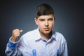 Angry boy isolated on gray background. He raised his fists to strike. Closeup Royalty Free Stock Photo