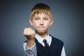 Angry boy isolated on gray background. He raised his fists to strike. Closeup Royalty Free Stock Photo