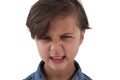 Angry boy standing against white background Royalty Free Stock Photo