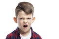 Angry boy of 7 years without a front tooth. Close-up. Isolated on white background Royalty Free Stock Photo