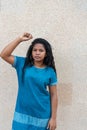 Angry and brave young African woman standing up with her fist.