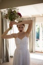 Angry bride throwing bouquet at home Royalty Free Stock Photo