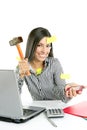 Angry brunette businesswoman with hammer