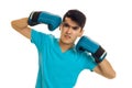 Angry brunette sportsman in blue boxing gloves and uniform practicing boxing isolated on white background Royalty Free Stock Photo