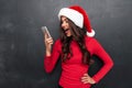 Angry brunette woman in red blouse and christmas hat screaming Royalty Free Stock Photo