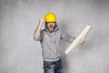 Angry builder holding blueprints in hand Royalty Free Stock Photo