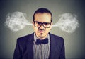 Angry business man, blowing steam coming out of ears, about to have nervous breakdown Royalty Free Stock Photo