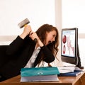 Angry business woman expressing rage at her desk in the office Royalty Free Stock Photo