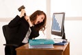 Angry business woman expressing rage at her desk in the office Royalty Free Stock Photo