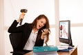 Angry business woman expressing rage at her desk in the office Royalty Free Stock Photo