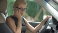 Angry business woman quarreling with husband on smartphone in car, stress Royalty Free Stock Photo