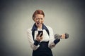 Angry business woman screaming on mobile phone lifting dumbbell Royalty Free Stock Photo