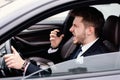 Angry businessman driving alone in his new car Royalty Free Stock Photo