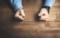 Angry businessman fists in the table.