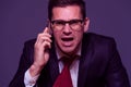 Angry businessman furiously talking on the phone Royalty Free Stock Photo